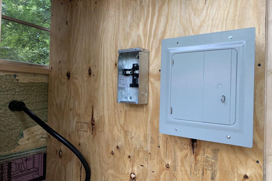 angled view of a spa panel and a main electrical panel